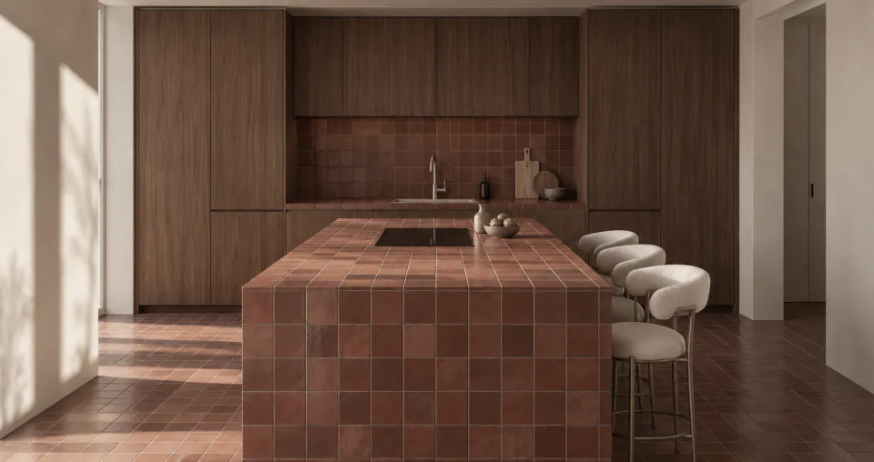 Dark timber kitchen with a terracotta-tiled island and curved stools