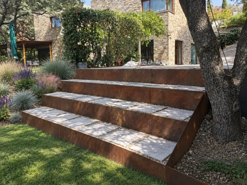 Corten steel terraced seating set into the lawn