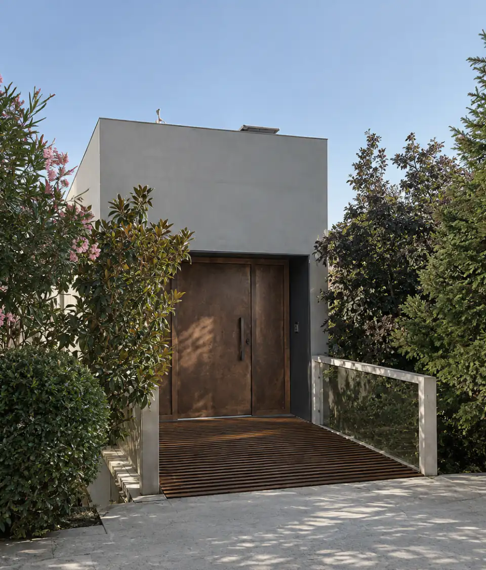 Entrance gate in a rendered wall