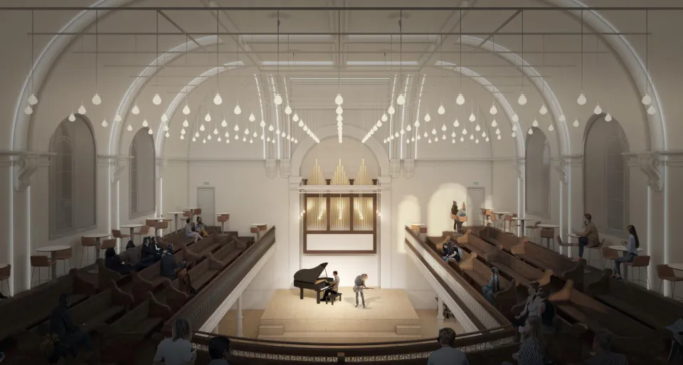 Church interior transformed into a concert hall, with a grand piano on stage under hanging lights