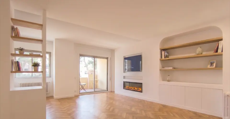 Living room with built-in shelves and a fireplace